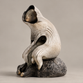 Hooded forest creature sculpture with an ivory-toned cloak and dark rock-like base, full view without text