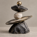 Full view of stacked abstract sculpture with tilted disc, pale sphere and gold-toned orb, without text